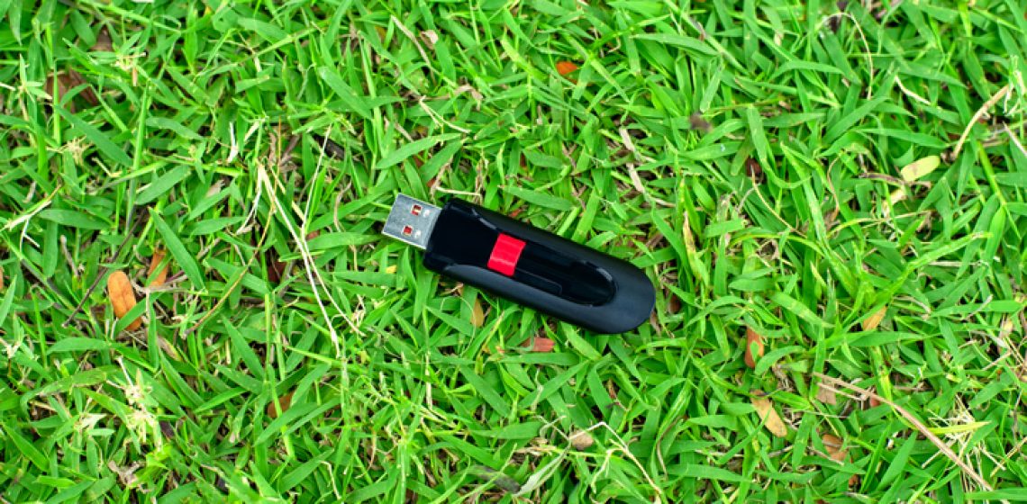 usb flash drive on grass background